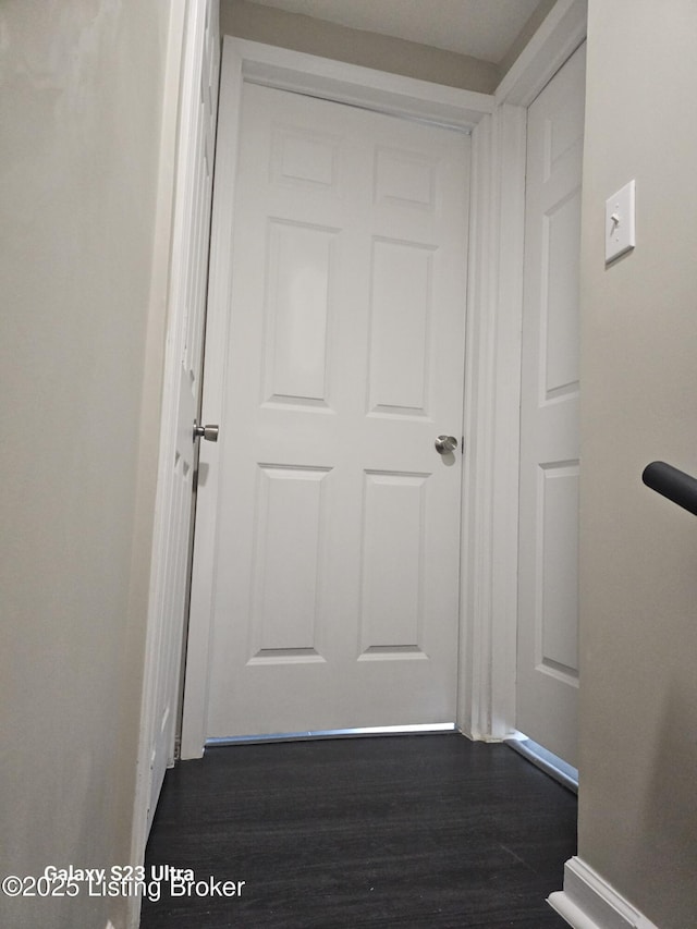 corridor featuring dark wood-type flooring