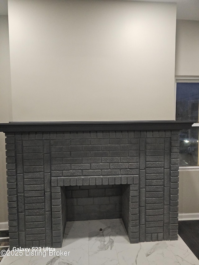 room details featuring a fireplace and baseboards