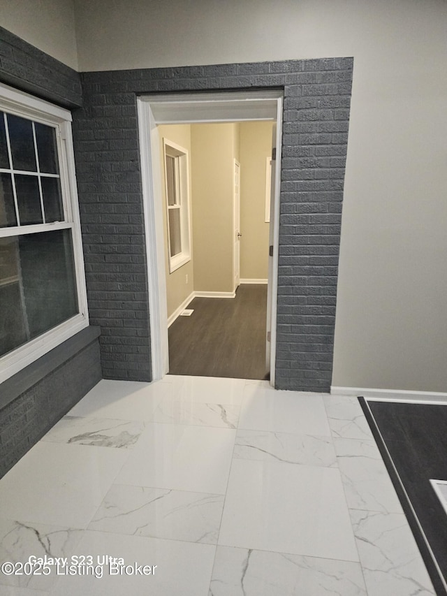 interior space with marble finish floor and baseboards