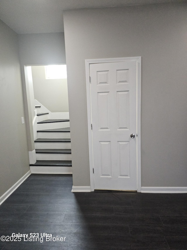 stairway with baseboards and wood finished floors