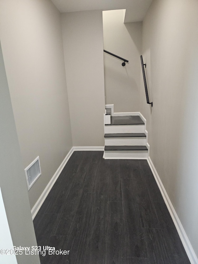 interior space with visible vents, baseboards, and wood finished floors