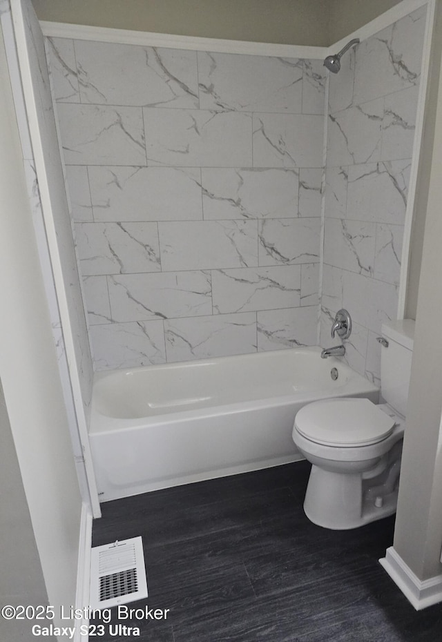 full bathroom featuring toilet, visible vents, tub / shower combination, and wood finished floors