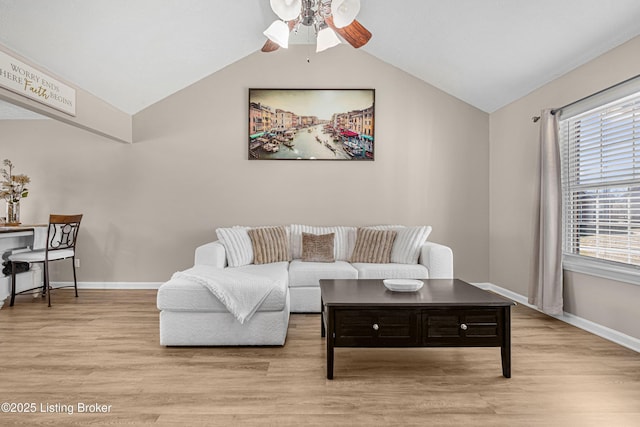 living room with baseboards, vaulted ceiling, and wood finished floors