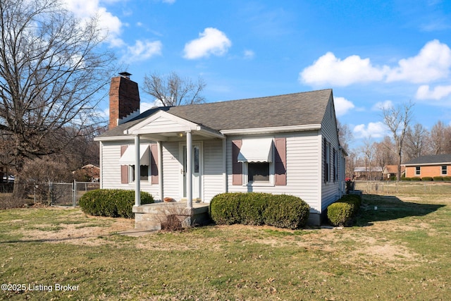 bungalow featuring roof with shingles, a chimney, a front yard, and fence