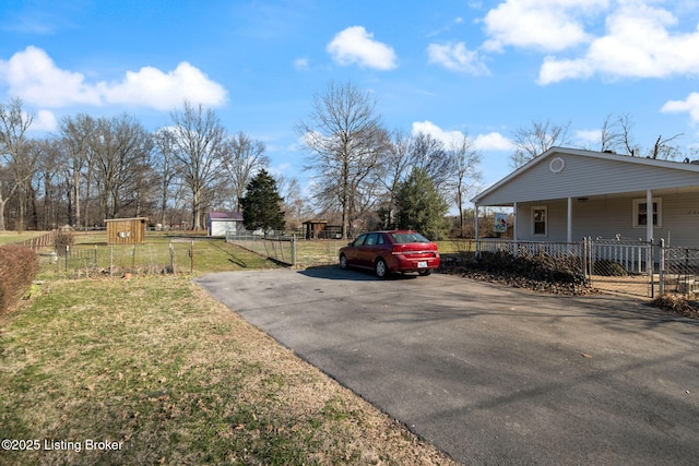 exterior space featuring driveway and fence