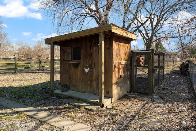 view of outbuilding featuring an outbuilding and fence