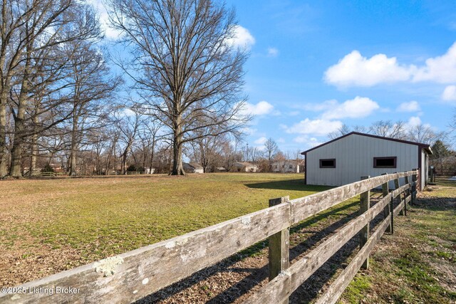 view of yard featuring an outbuilding, fence, and an outdoor structure