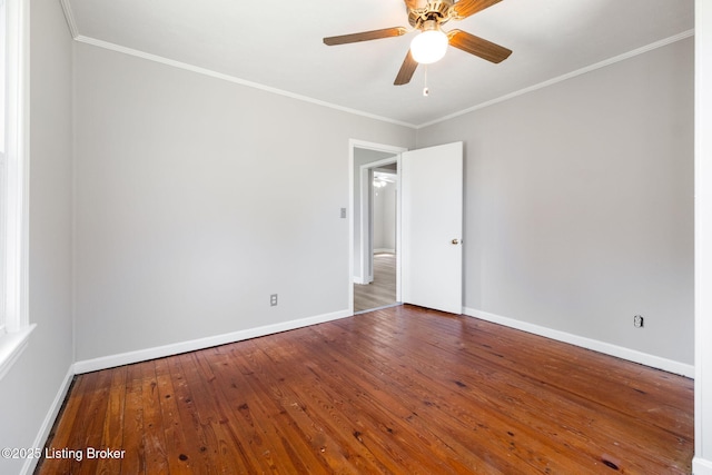 spare room featuring ornamental molding, ceiling fan, baseboards, and hardwood / wood-style floors