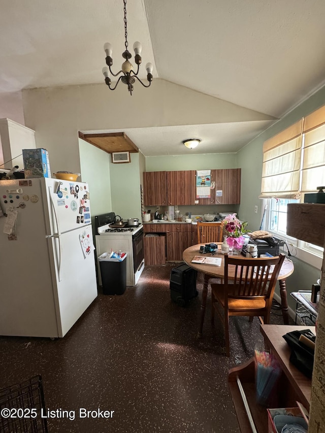 dining area featuring lofted ceiling, a chandelier, and visible vents