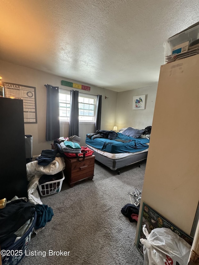 bedroom with a textured ceiling and carpet