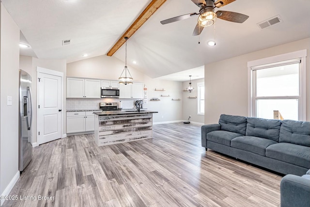 living room with lofted ceiling with beams, baseboards, visible vents, and light wood-style floors