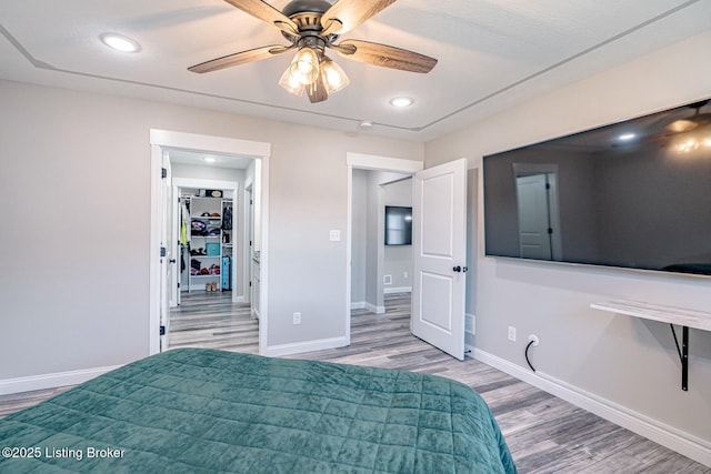 unfurnished bedroom with recessed lighting, ceiling fan, baseboards, and wood finished floors