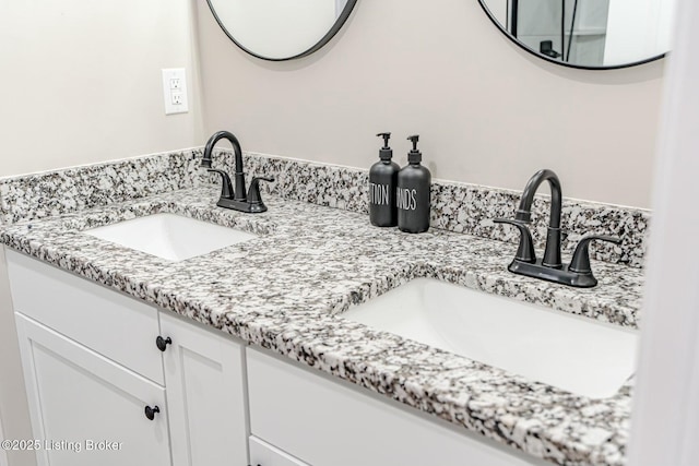 full bathroom with double vanity and a sink