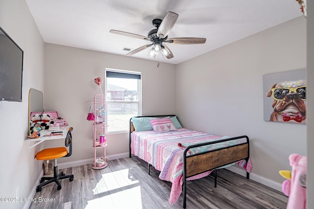 bedroom with visible vents, ceiling fan, baseboards, and wood finished floors