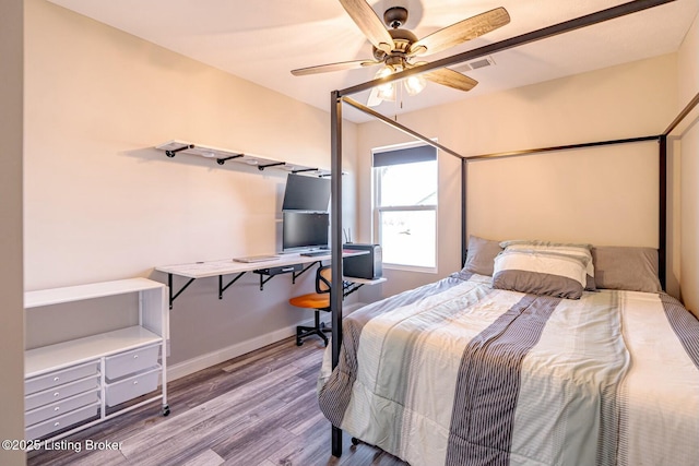 bedroom with baseboards, visible vents, ceiling fan, and wood finished floors