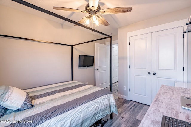 bedroom with ceiling fan, a closet, and wood finished floors