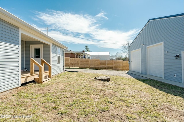 view of yard featuring an outbuilding and fence