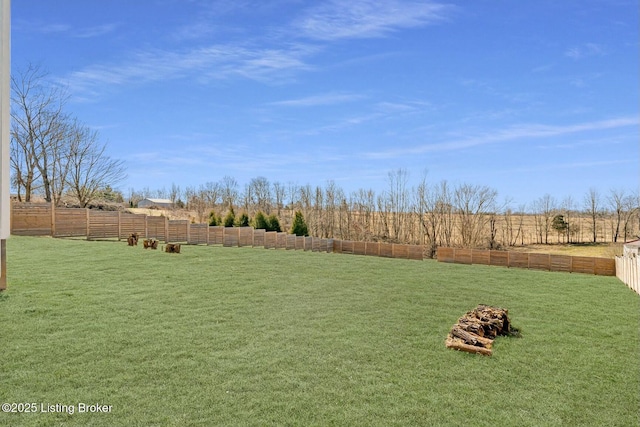 view of yard featuring a rural view and fence