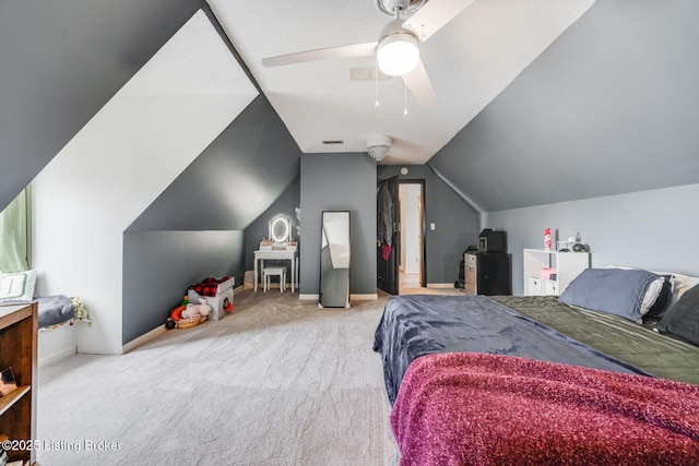 carpeted bedroom with vaulted ceiling, a ceiling fan, and baseboards