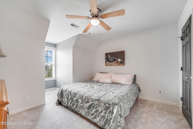 bedroom featuring a textured ceiling, carpet floors, visible vents, and baseboards