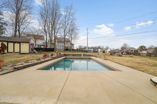 view of pool with a patio, a lawn, fence, and a fenced in pool