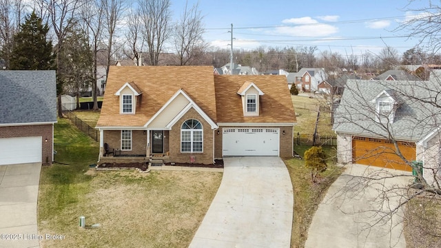 cape cod home with brick siding, a front yard, fence, a garage, and driveway