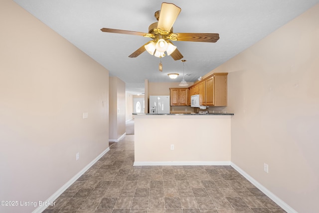 kitchen with ceiling fan, white appliances, dark countertops, and baseboards