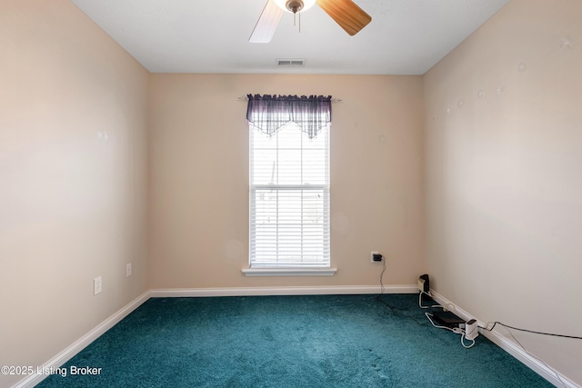 carpeted spare room featuring ceiling fan, visible vents, and baseboards