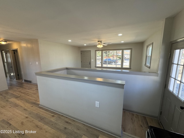 kitchen with light countertops, wood finished floors, visible vents, and recessed lighting