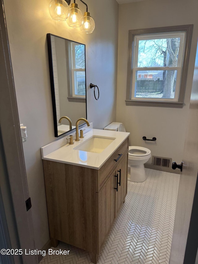 bathroom with plenty of natural light, vanity, visible vents, and tile patterned floors