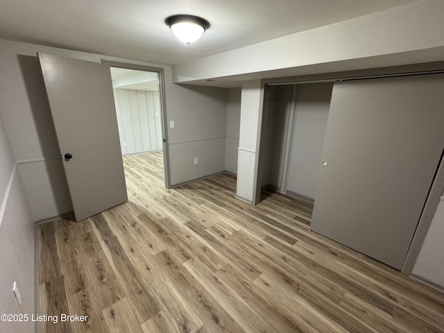 unfurnished bedroom featuring a closet and light wood-style floors