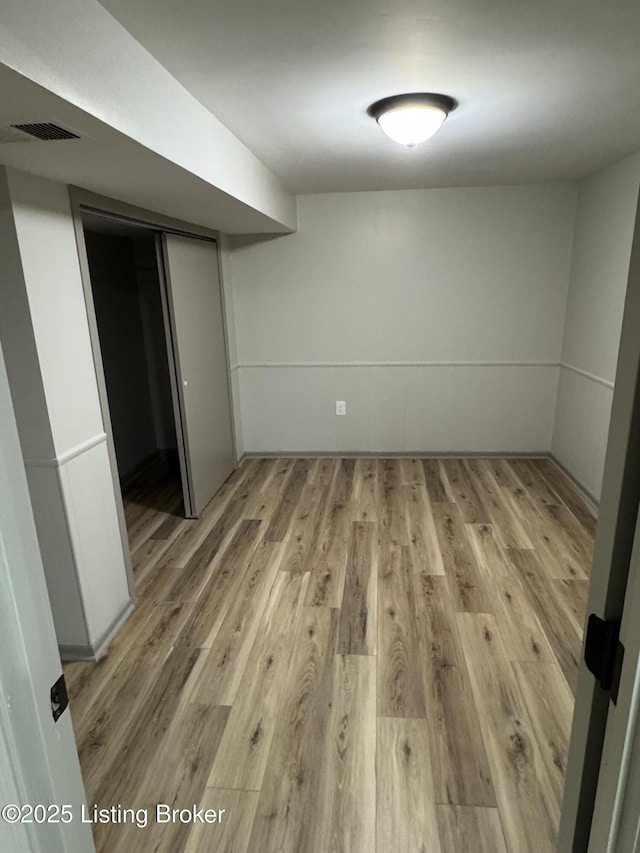 spare room with light wood-type flooring and visible vents