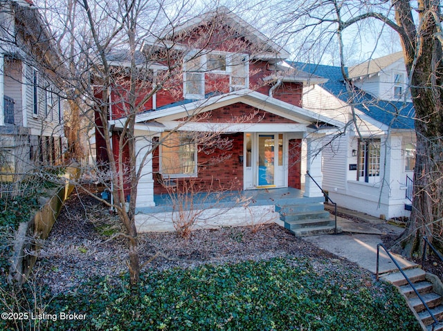 view of front of property featuring a porch and brick siding