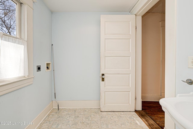 laundry area featuring a healthy amount of sunlight, baseboards, washer hookup, and electric dryer hookup