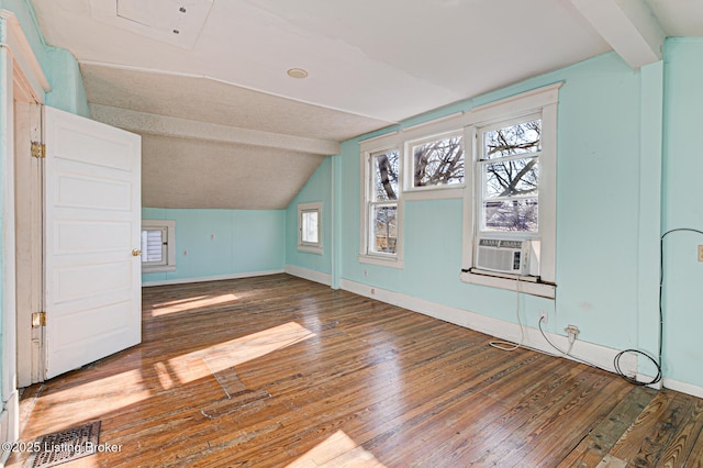 bonus room with dark wood-style floors, visible vents, and vaulted ceiling with beams