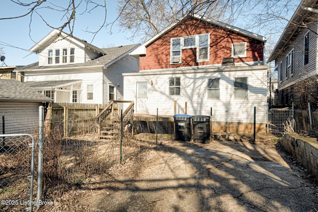 back of house featuring fence and central AC