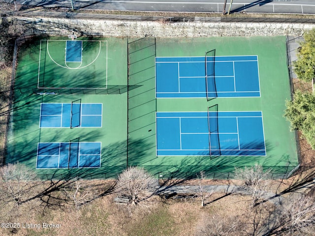 view of side of property with a tennis court