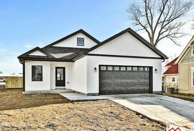 modern farmhouse style home featuring an attached garage, concrete driveway, and roof with shingles