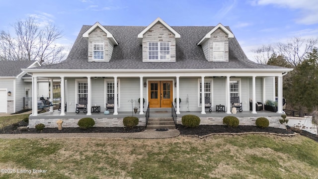 view of front of house featuring a porch, a front yard, french doors, and roof with shingles