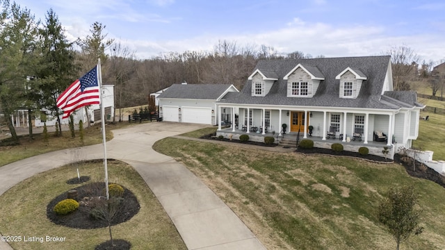 view of front of home featuring driveway, a shingled roof, an attached garage, covered porch, and a front yard