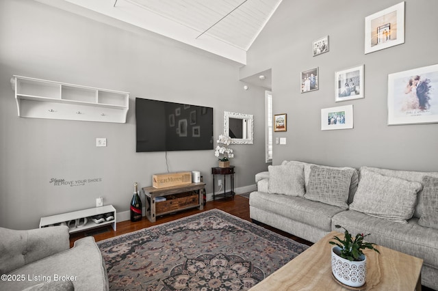 living room with dark wood-style floors, baseboards, and high vaulted ceiling