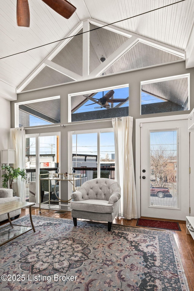 living room featuring ceiling fan, high vaulted ceiling, and wood finished floors