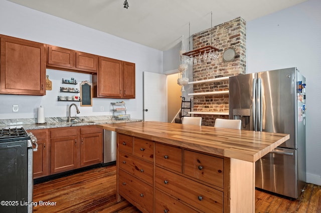 kitchen with open shelves, stainless steel appliances, dark wood-type flooring, a sink, and wood counters