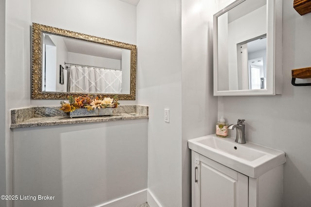 bathroom featuring vanity and baseboards