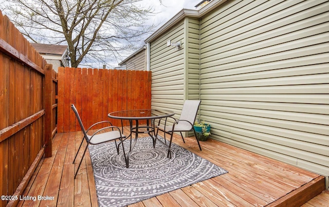 wooden deck featuring outdoor dining area and fence