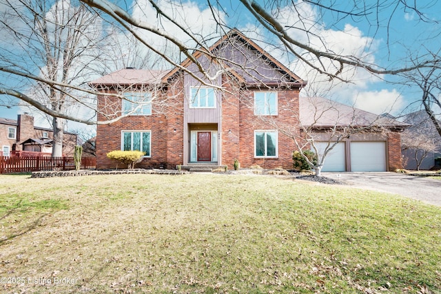 traditional-style home featuring a front yard, brick siding, fence, and driveway