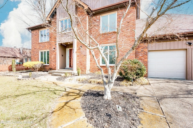 view of front of house featuring brick siding, driveway, and an attached garage