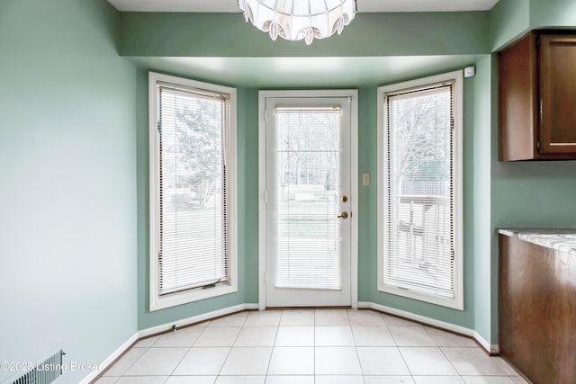 entryway with visible vents, baseboards, and light tile patterned floors