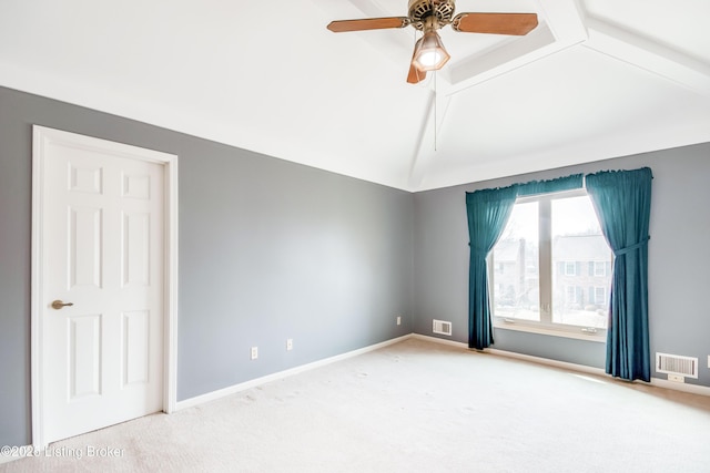 carpeted spare room featuring a ceiling fan, visible vents, lofted ceiling with beams, and baseboards