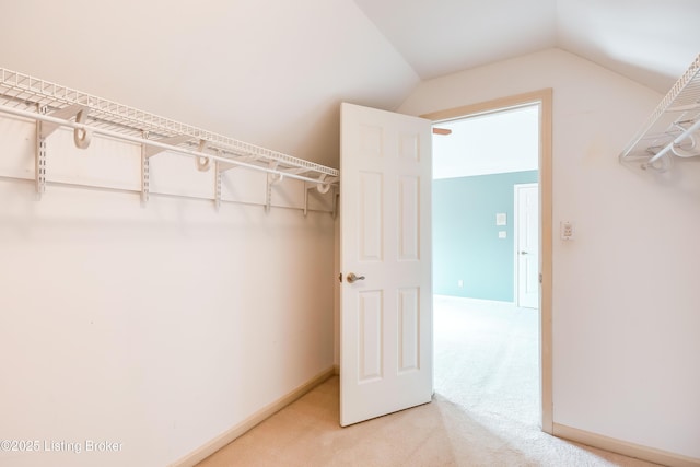 spacious closet with carpet and lofted ceiling